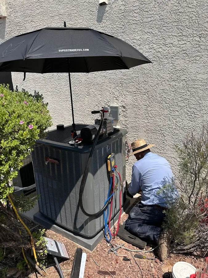 HVAC technician performing outdoor AC maintenance in Tarrytown